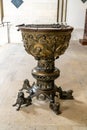 Bronze baptismal font with many decorations