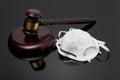 N95 face mask and gavel isolated on black background Royalty Free Stock Photo