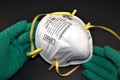 N95 Respirator hold by both hands wearing latex gloves