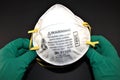 N95 Respirator hold by hands with surgical gloves Royalty Free Stock Photo