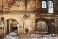 Ruin, the wall of an old destroyed residential building. The window and door openings are dominated without door frames.