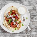 Naan bread with grilled chicken, red sweet peppers and yoghurt on a light background Royalty Free Stock Photo