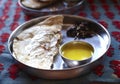 Naan flat bread with daal soup in thali