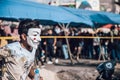 Boy wearing Guy Fawkes mask running in Lebanese Civil Protest