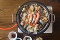 Nabe Japanese hot pot dishes including prawns, salmon, pork, vegetables and mushrooms at the restaurant in Hokkaido, Japan