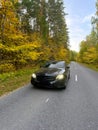 Naberezhnye Chelny, Russia - October 1, 2023: Mercedes-Benz E200 car stands on the road in the autumn forest