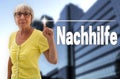 Nachhilfe (in german tutoring) touchscreen is shown by senior Royalty Free Stock Photo