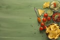 Nacho chips arranged on green wooden surface