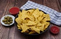 Nachos in a bowl with tomato sauce and olives. Tortilla chips isolated on white background Royalty Free Stock Photo