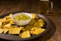 Nachos chips, salsa guacamole and beer