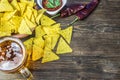 Nachos corn chips with classic tomato salsa. Fresh cold beer is perfect with savory snacks. Royalty Free Stock Photo