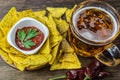 Nachos corn chips with classic tomato salsa. Fresh cold beer is perfect with savory snacks. Royalty Free Stock Photo