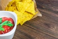 Nachos corn chips with classic tomato salsa. Fresh cold beer is perfect with savory snacks. Royalty Free Stock Photo