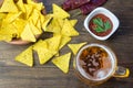 Nachos corn chips with classic tomato salsa. Fresh cold beer is perfect with savory snacks. Royalty Free Stock Photo