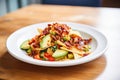 nachos with crispy bacon bits and diced avocado Royalty Free Stock Photo