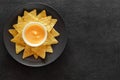 Nachos on grey plate and cheese salsa, on dark background, top view, space to copy text Royalty Free Stock Photo