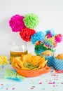 Nachos with guacamole and beer with colorful flowers.