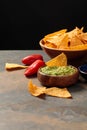 Nachos with guacamole and chili peppers