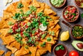 Nachos. Totopos with sauces. Mexican food concept. Yellow corn totopos chips with different sauces salsas - pico del Royalty Free Stock Photo