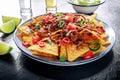 Nachos, Mexican food, tortilla chips with beef and fresh vegetables Royalty Free Stock Photo