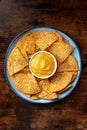 Nachos, Mexican tortilla chips, shot from above on a wooden table Royalty Free Stock Photo