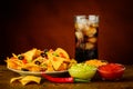 Nachos plate, dip and cola drink