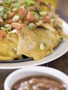 Nachos with salsa on table