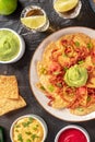 Nachos, shot from above with tequila and various dips, Mexican food and drink Royalty Free Stock Photo