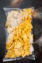 Nachos, triangle traditional Mexican corn appetizer, on old dark rustic background, top view or flat lay