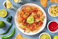 Nachos with various dips, overhead flat lay shot Royalty Free Stock Photo