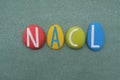 NACL, Sodium chloride, chemical formula of salt composed with multi colored stone letters