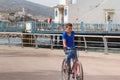 NADOR, MOROCCO - MAY 22, 2017: Arabian boy with an unkind suspicious look on a bicycle rides along the promenade near Mar Chica