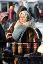Nenets woman sells warm national shoes made of reindeer fur