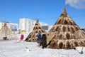 Reindeer herders install dwellings near modern city buildings