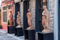 Ancient Greek full-size statue replicas outside a shop facade in Nafplio, Greece