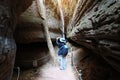 Naga cave, Asian woman using smart phone to take a photo of Naga scales rock stone mountain in Phu Langka National Park, Bueng Kan