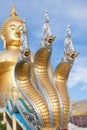 Naga and large gold buddha statue under construction in Thai temple with clear sky.WAT MUANG, Ang Thong, THAILAND. Royalty Free Stock Photo