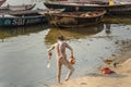 Naga Sadhu holy man smears ash after morning dip in Ganga river in Varanasi. India Royalty Free Stock Photo