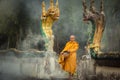 Naga Statue with Monk alms round Royalty Free Stock Photo