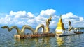 Naga statues and pagodas on the water.