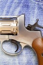 Nagan revolver on blue jeans background