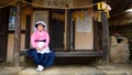 Nagan/South Korea-29.05.2018:The woman in traditional dress sitting inside the Naganeupseong folk village Royalty Free Stock Photo
