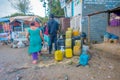 NAGARKOT, NEPAL OCTOBER 11, 2017: Unidentified woman walking at aoutdoors to fill with water some plastic trays in