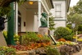 NAGASAKI, Japan. Colonial style white wooden building, autumn flowers and man`s statue in Glover Garden in Nagasaki, Japan.