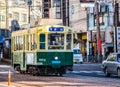 Nagasaki, Japan - 4 November 2020: Green and yellow tram in Nagasaki