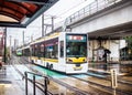 Nagasaki, Japan - 2 November 2020: Yellow and white tram on a rainy day in Nagasaki