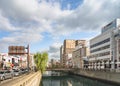 Car fraffic on the Kokaidomae street along the Nakashima river crossed by Kurogane bridge in Nagasaki. Royalty Free Stock Photo