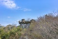 Concrete observation deck overlooking the forest trees and plants of the Kazagashira park.