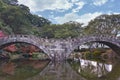 The Meganebashi or Spectacles Stone Bridge in the pond at Isahaya Park during autumn season. Royalty Free Stock Photo
