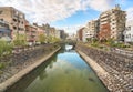 Nakashima river crossed by a stone path in front of the higashi shimbashi stone bridge.